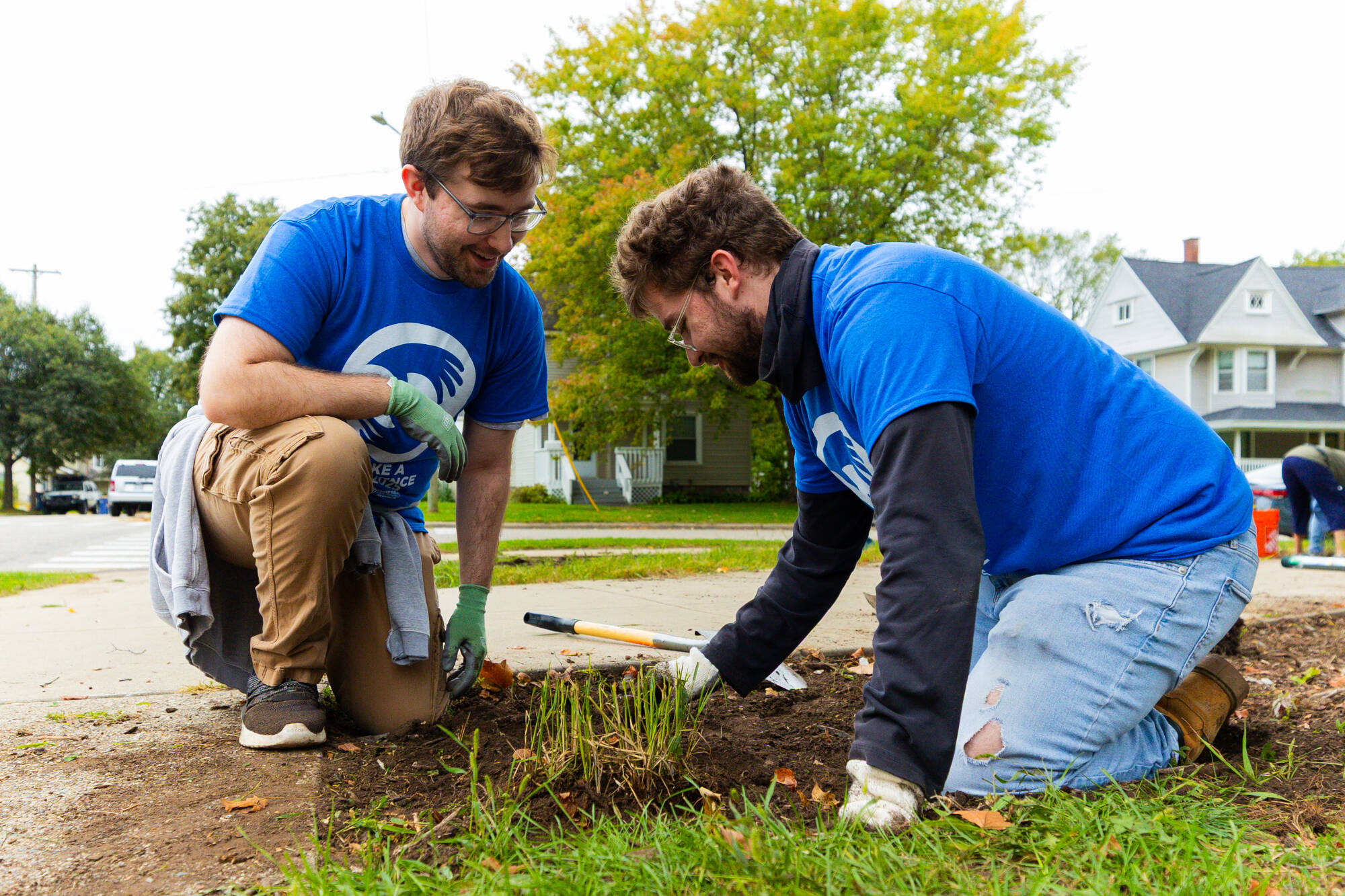 Students planting plants in the ground